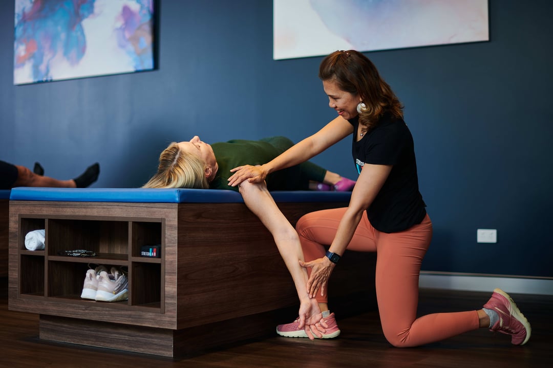 static stretching an stretching bed with the help of an instructor