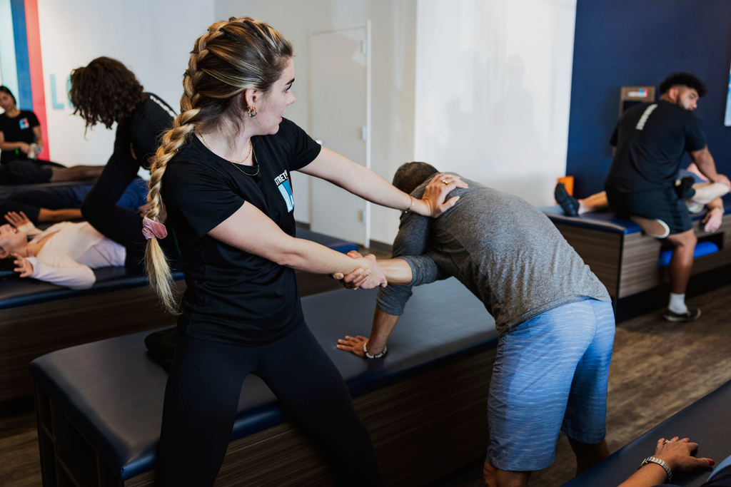 tips for assisted stretching a shoulder in a stretch class