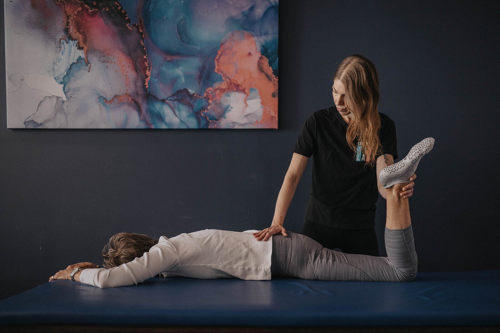 Woman performing a PNF stretch with assistance