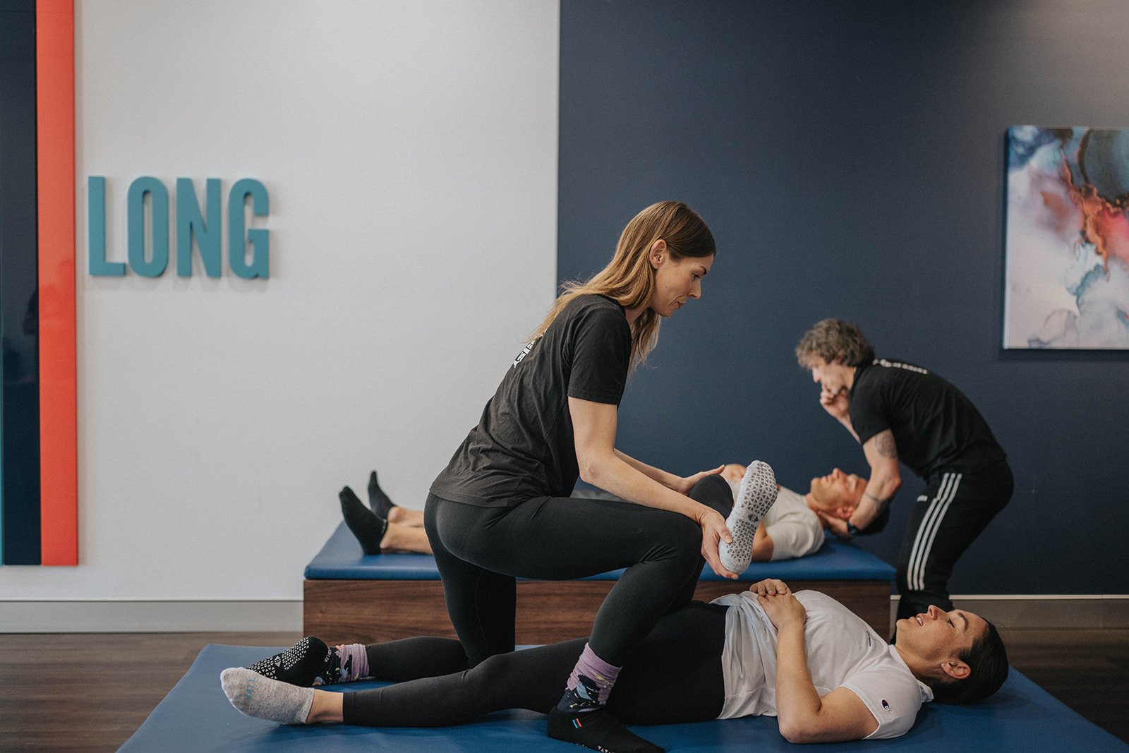 Woman performing an adductor stretch with help