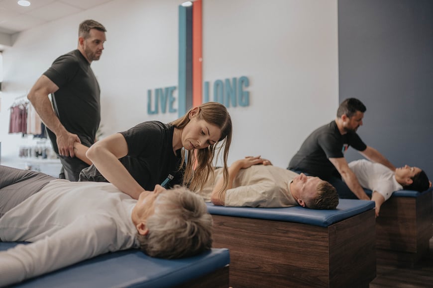 elderly woman at an assisted stretching class